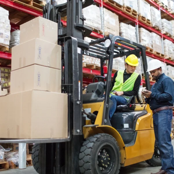 Forklift operator performing pre-operational checks and lifting loads safely