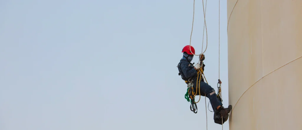 Worker using fall protection equipment while completing Working at Heights training in Ontario.
