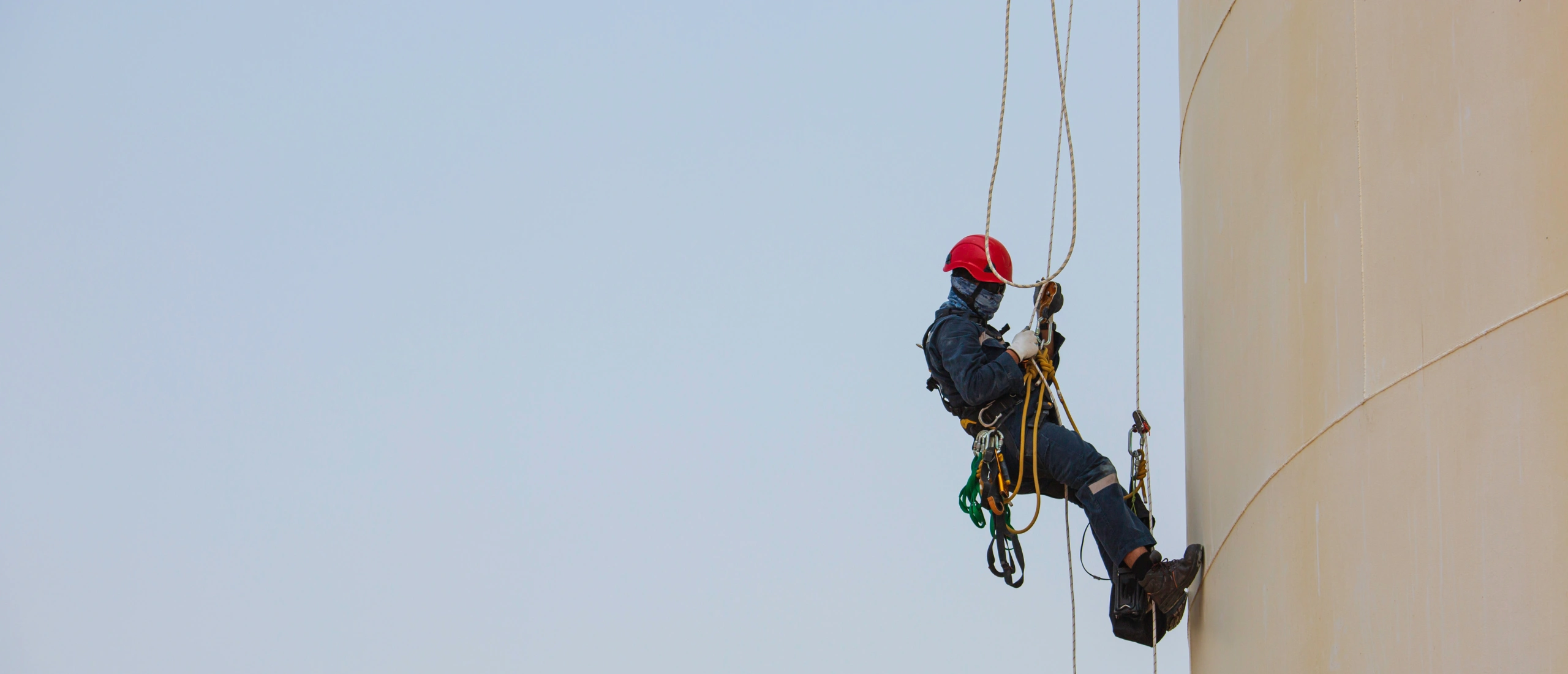 Worker using fall protection equipment while completing Working at Heights training in Ontario.
