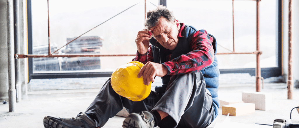 Worker walking on a wet or uneven surface representing slip, trip, and fall hazards in Ontario workplaces.