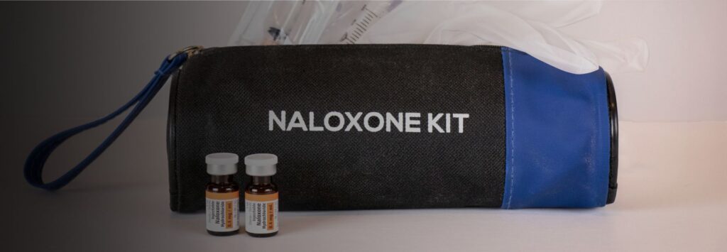 Naloxone kit included in a workplace first aid setup to respond to potential opioid overdoses.